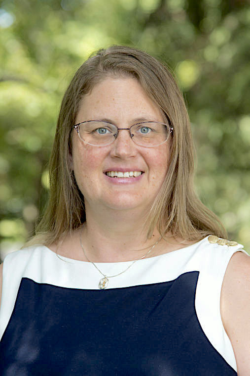 A woman with glasses and a white shirt